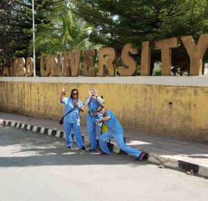 Team members in front of Ambo University sign